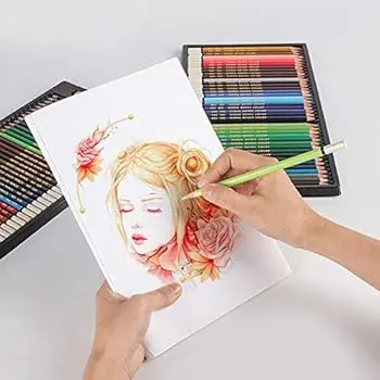 Artist sketching with Kalour graphite pencils on textured paper.